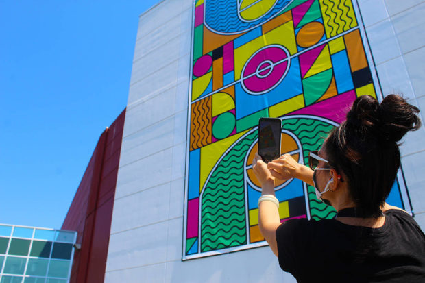 A visitor interacts with a one-of-a-kind art piece (Megan Atkins-Baker)